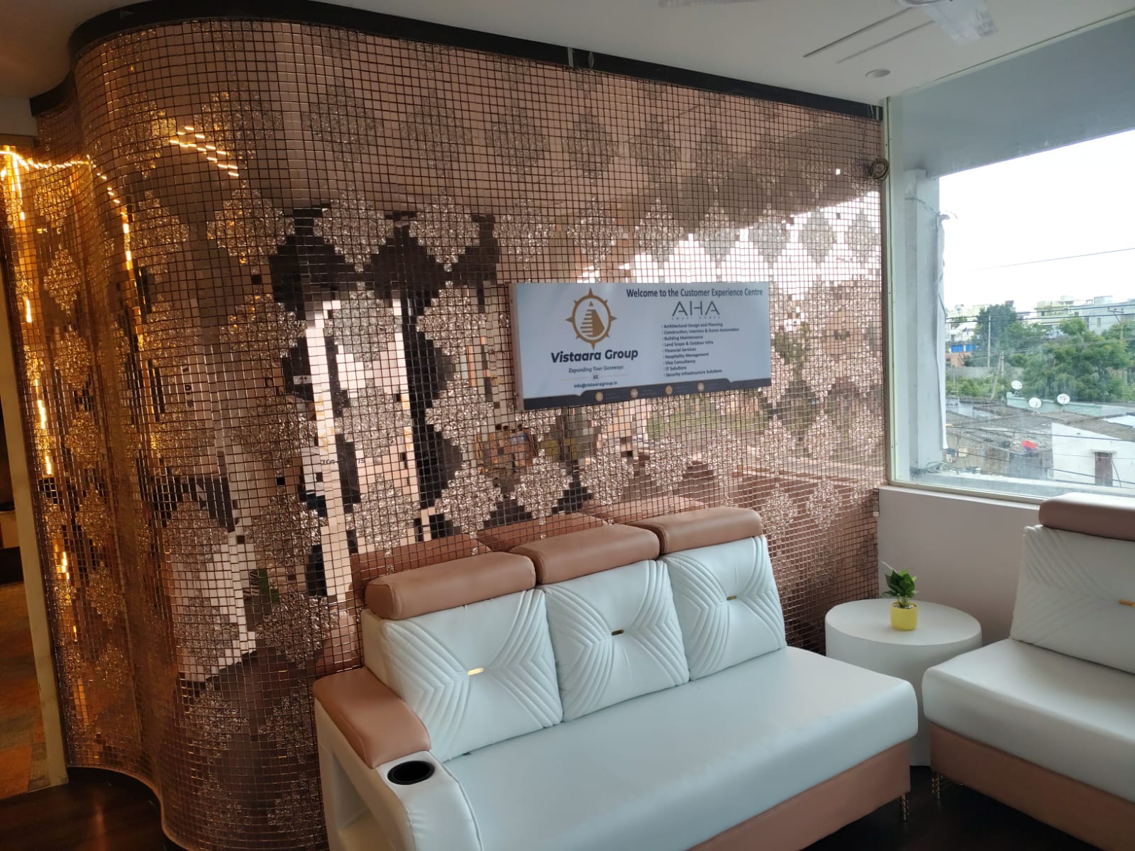 Customer Experience Centre — rose-gold mosaic feature wall